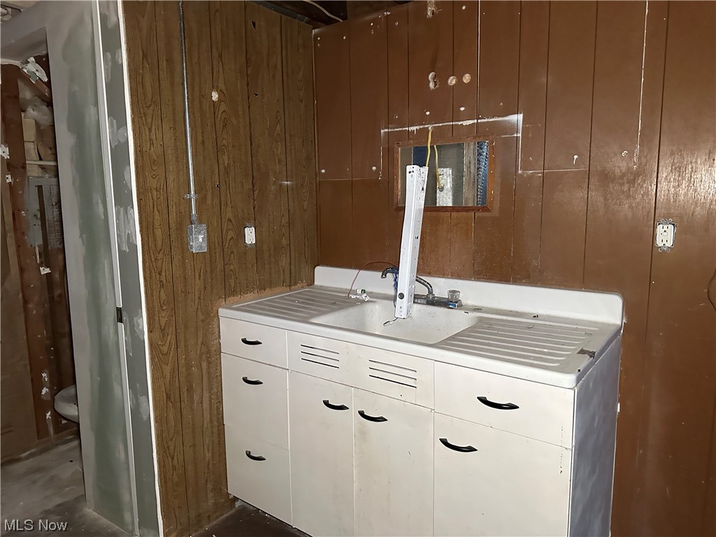 5112 Reed Avenue Ashtabula, OH 44004 - Photo 17 of 21 Bathroom featuring vanity, toilet, and wooden walls