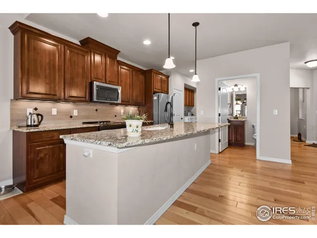 a kitchen with kitchen island a sink stainless steel appliances and cabinets