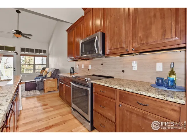 a kitchen with stainless steel appliances granite countertop a sink stove and microwave
