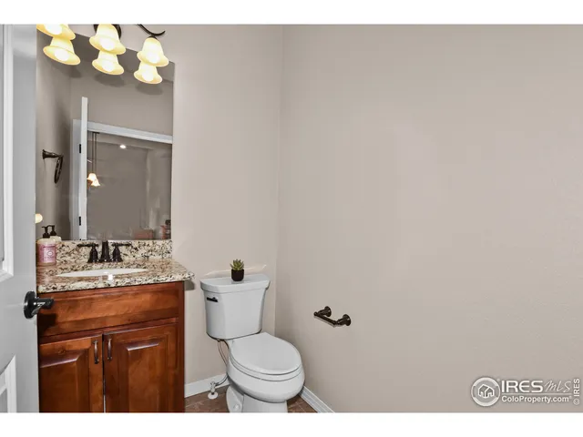a bathroom with a sink vanity mirror and toilet