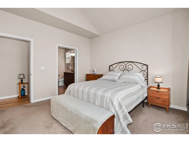 a bedroom with a bed and a lamp