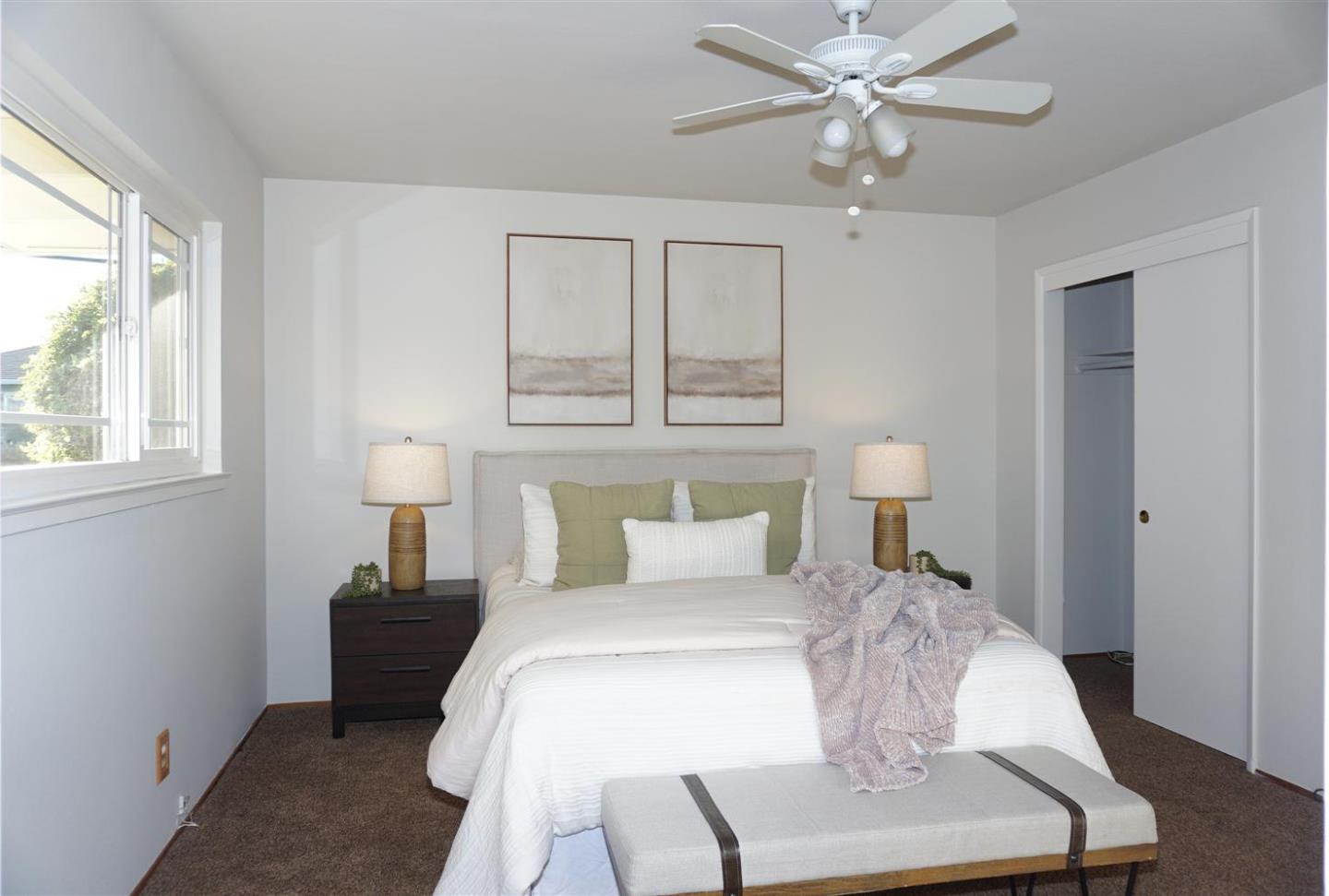 580 Pomeroy Avenue Santa Clara, CA 95051 - Photo 8 of 15 a bedroom with a bed and a lamp