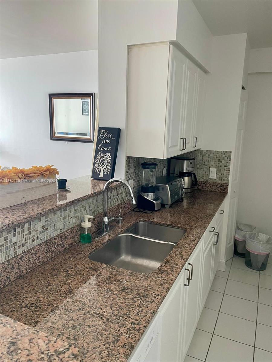 1155 Brickell Bay Drive, Unit 1805 Miami, FL 33131 - Photo 11 of 11 a kitchen with a sink and a stove top oven