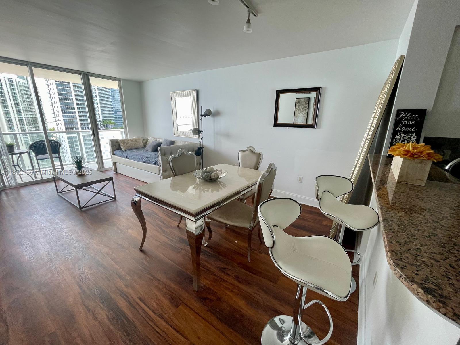 1155 Brickell Bay Drive, Unit 1805 Miami, FL 33131 - Photo 2 of 11 a workspace with furniture and a window