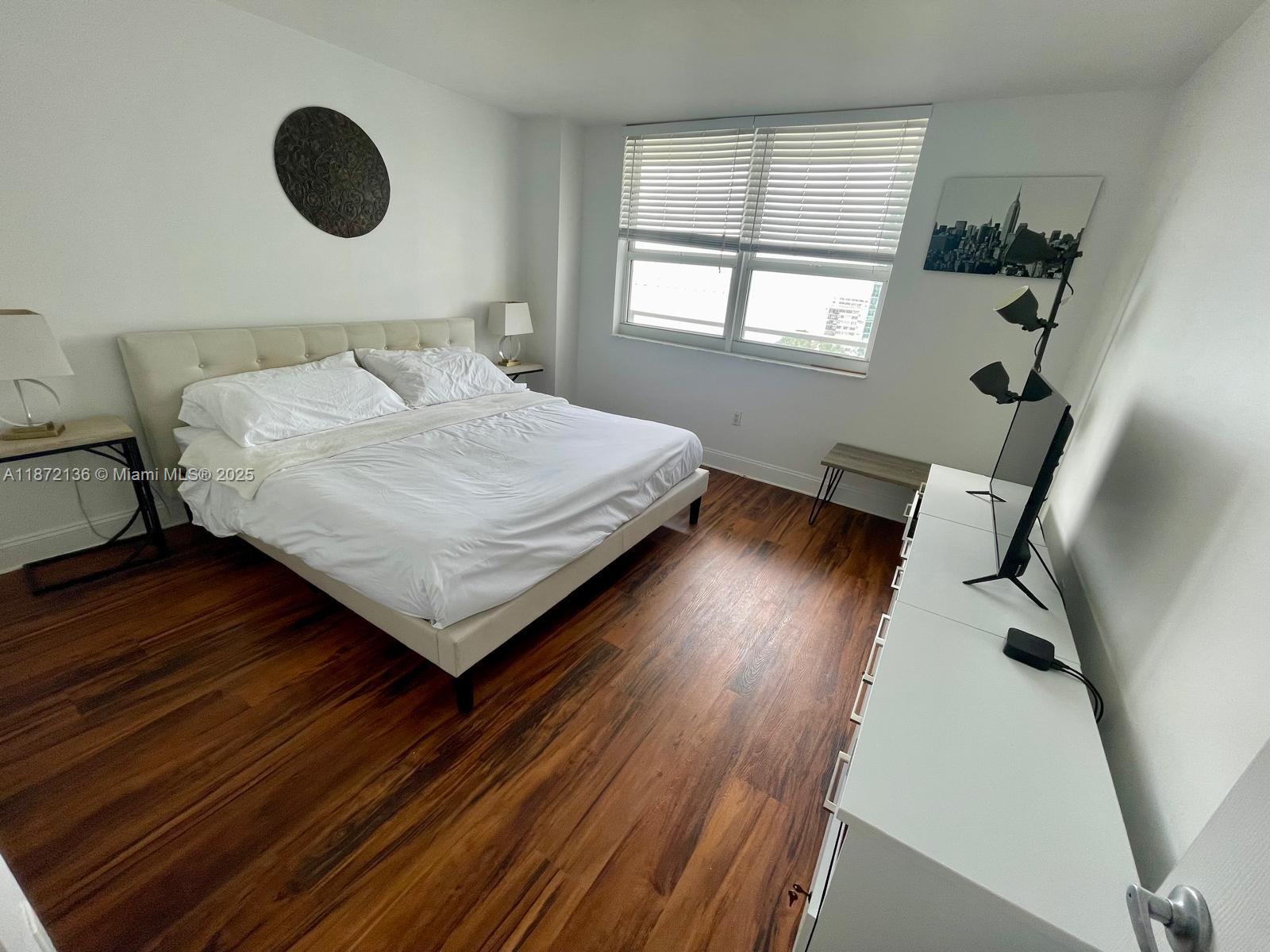 1155 Brickell Bay Drive, Unit 1805 Miami, FL 33131 - Photo 8 of 11 a bedroom with a bed and window