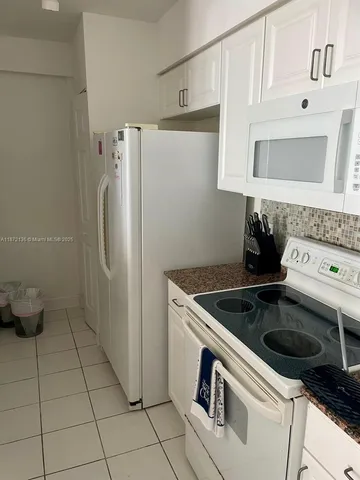a kitchen with a stove and a refrigerator