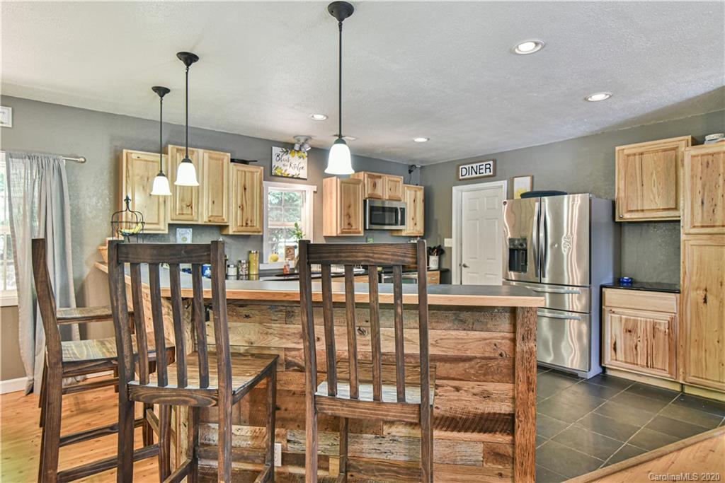 90 Devlin Street Canton, NC 28716 - Photo 14 of 25 a kitchen with stainless steel appliances granite countertop a refrigerator a stove and a wooden floors