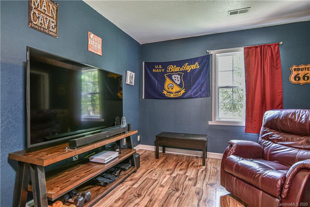 90 Devlin Street Canton, NC 28716 - Photo 21 of 25 a living room with furniture and a flat screen tv