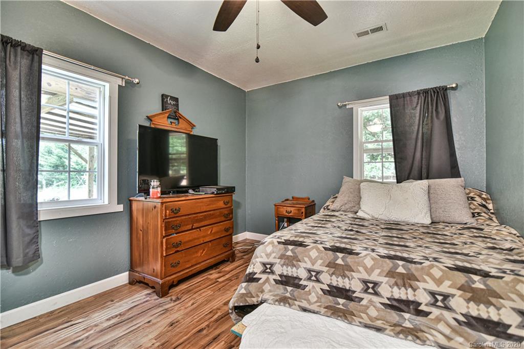 90 Devlin Street Canton, NC 28716 - Photo 22 of 25 a bedroom with a bed and a flat screen tv