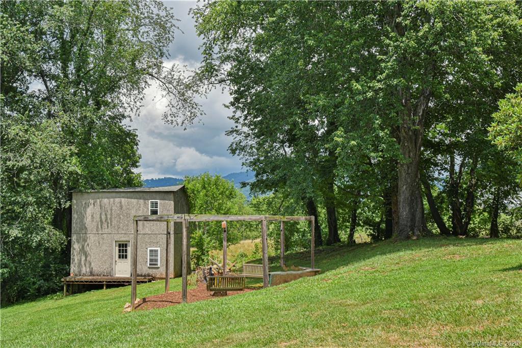 90 Devlin Street Canton, NC 28716 - Photo 4 of 25 a view of backyard with a barn and large trees