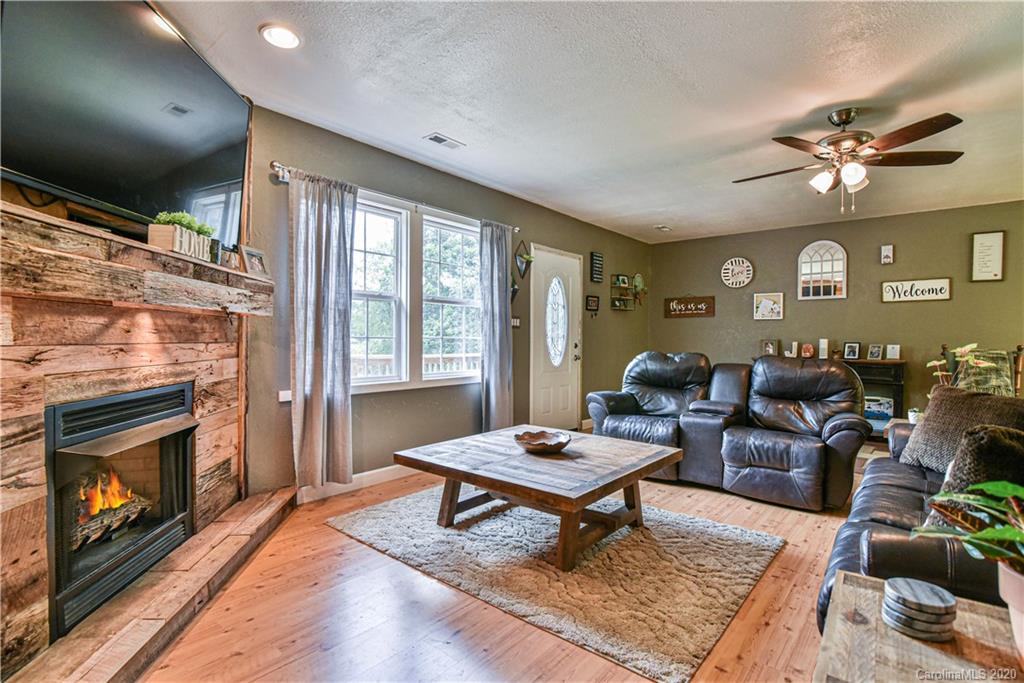 90 Devlin Street Canton, NC 28716 - Photo 10 of 25 a living room with furniture a rug and a fireplace