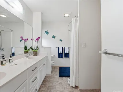 a bathroom with a double vanity sink mirror and cabinets