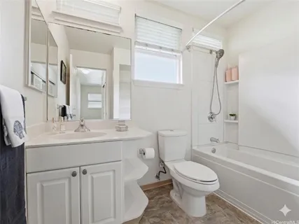 a bathroom with a sink toilet vanity and shower
