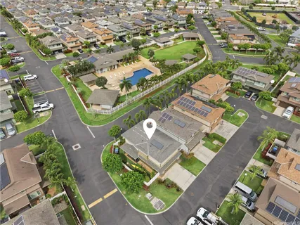 an aerial view of a residential houses with yard