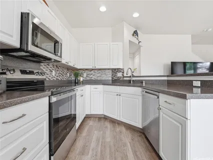 a kitchen with a sink stove and cabinets