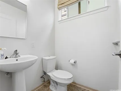 a bathroom with a sink toilet and a mirror