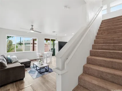a living room with furniture and stairs