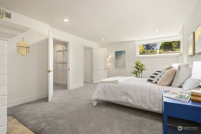 a bedroom with a bed and wall painting