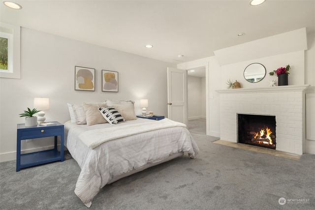 a bedroom with a bed and a fireplace