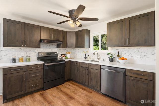 a kitchen with a sink cabinets and window