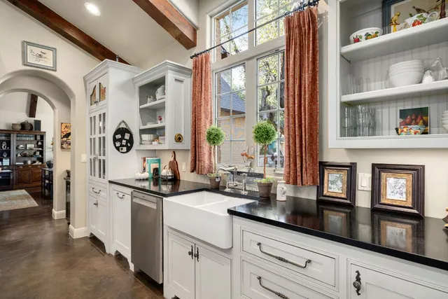 a dining room with stainless steel appliances kitchen island granite countertop a dining table and chairs