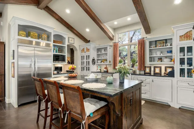 a spacious bedroom with a bed and dresser