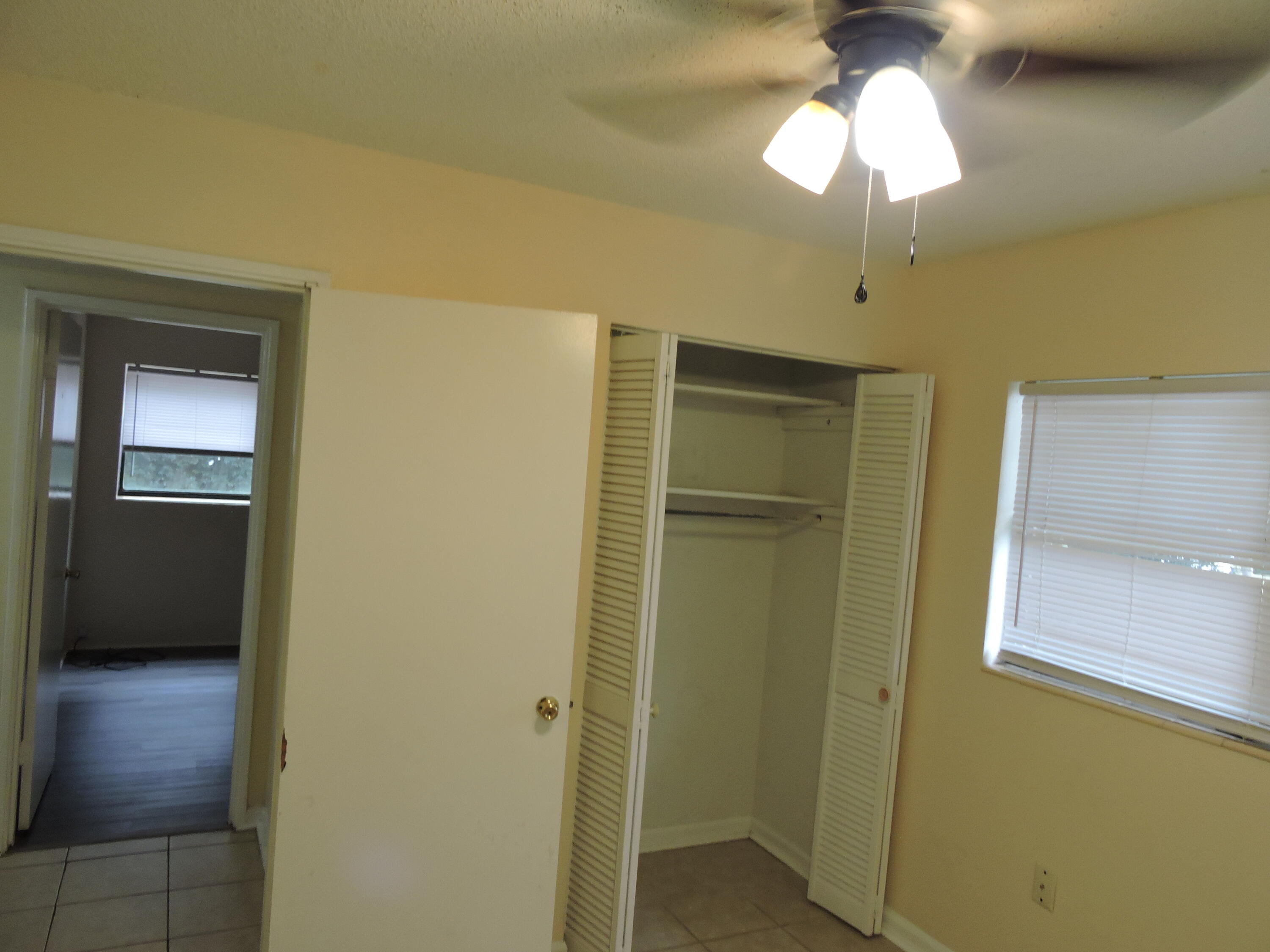 120 Sikes Drive Crestview, FL 32539 - Photo 16 of 18 a view of a hallway with a chandelier fan and a table