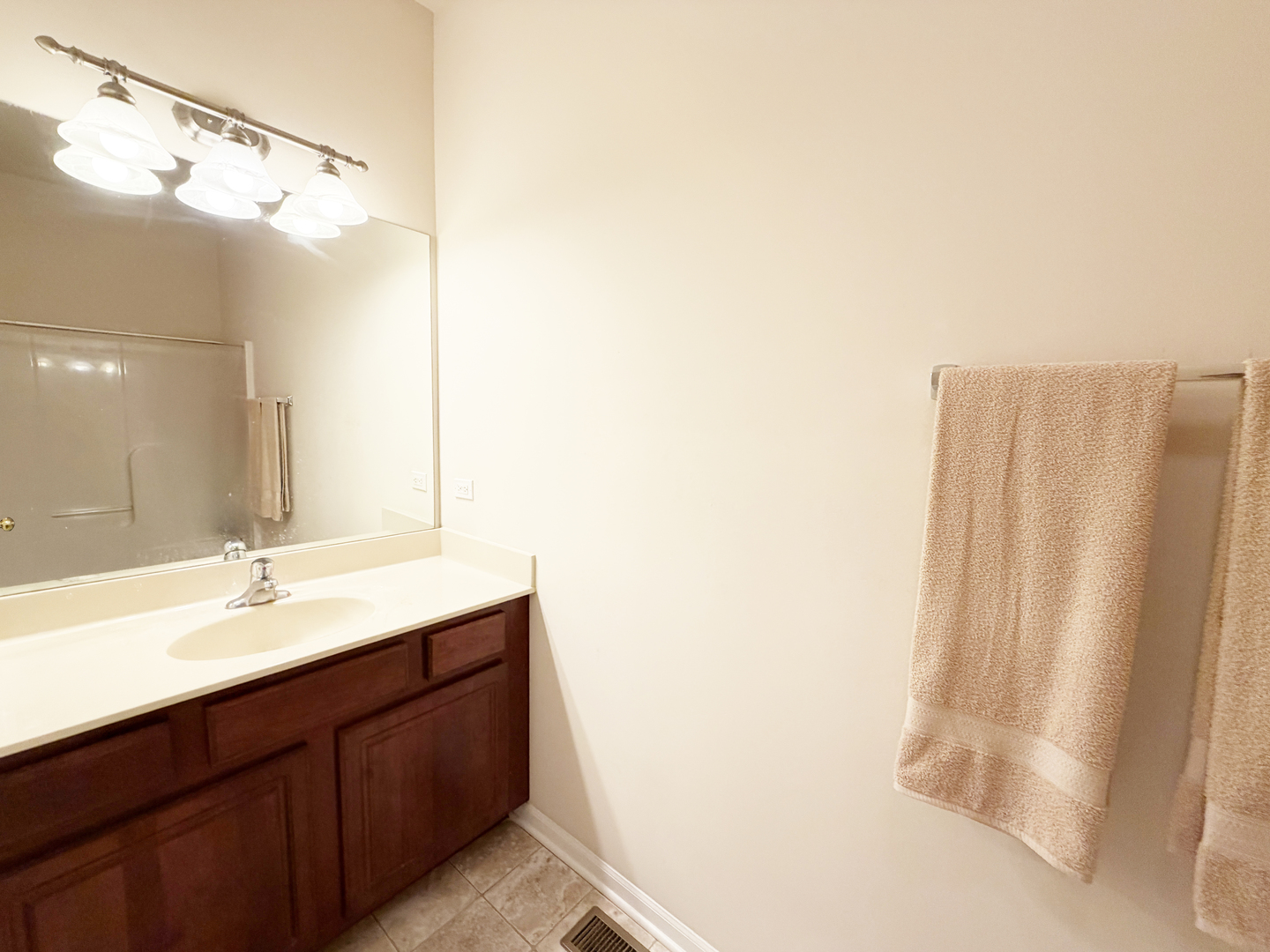 Undisclosed Address Elgin, IL 60120 - Photo 15 of 22 a bathroom with a double vanity sink and a mirror