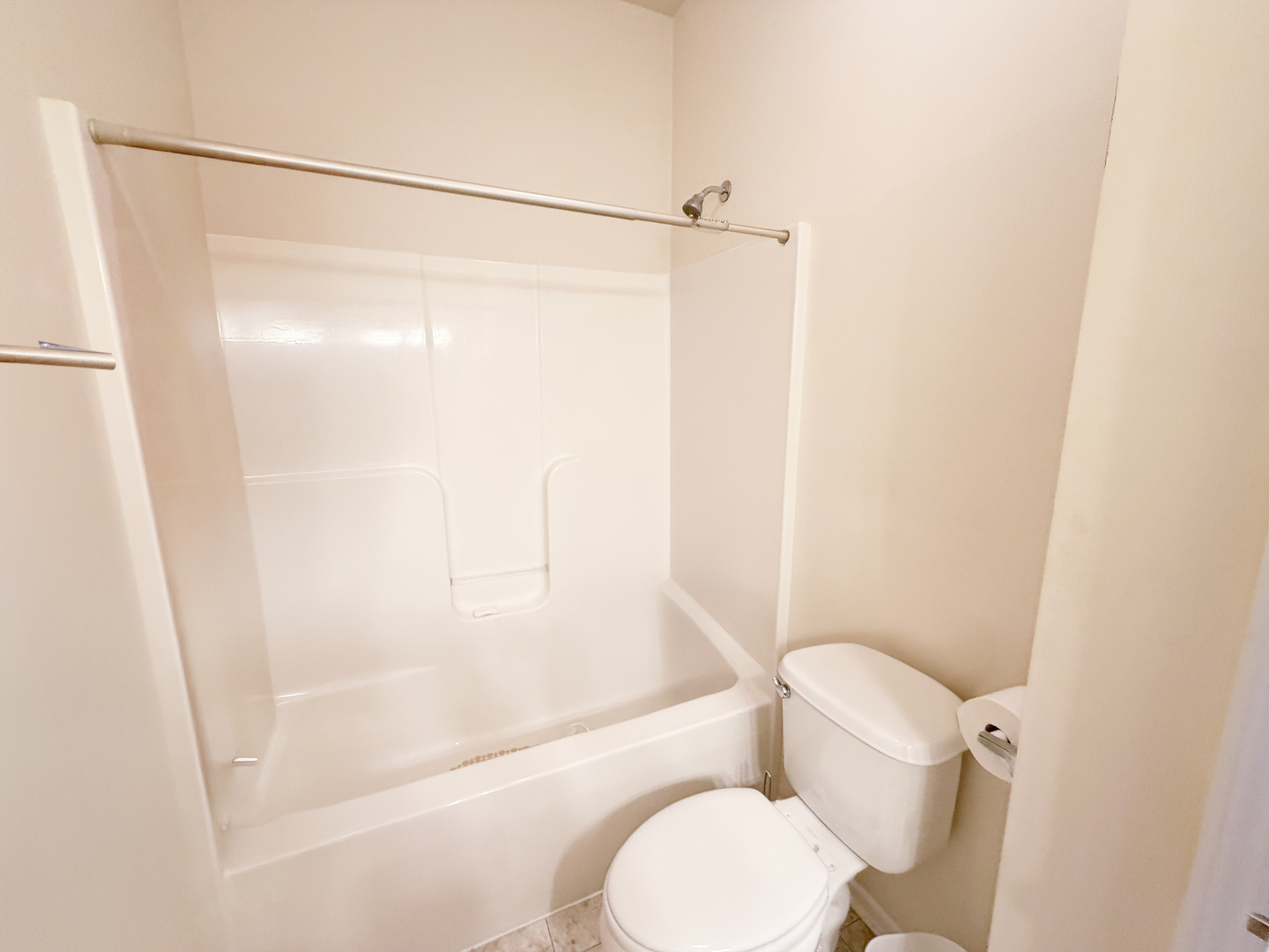 Undisclosed Address Elgin, IL 60120 - Photo 16 of 22 a white toilet sitting next to a bath tub