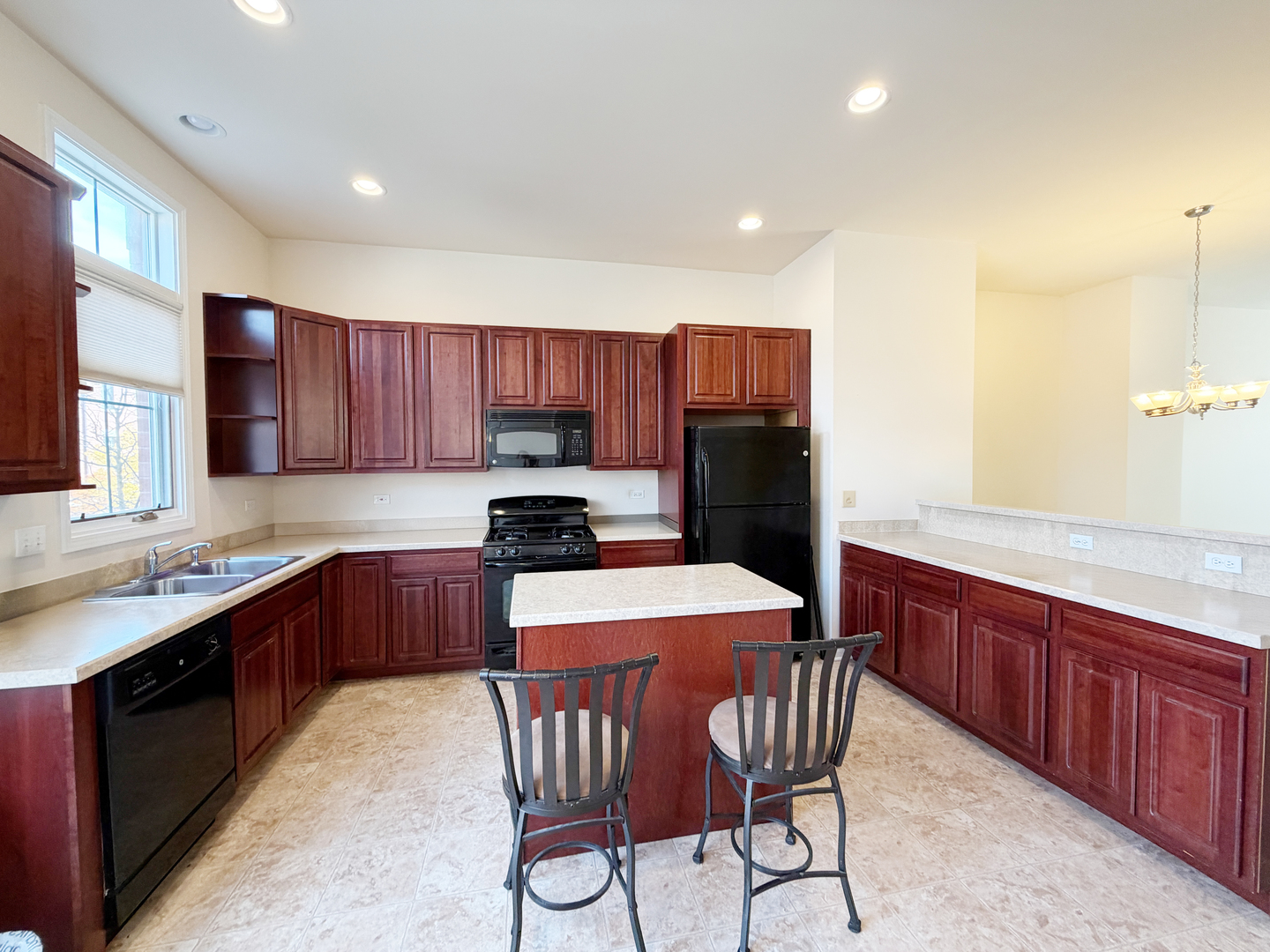 Undisclosed Address Elgin, IL 60120 - Photo 5 of 22 a kitchen with stainless steel appliances granite countertop wooden cabinets a stove a sink and a refrigerator