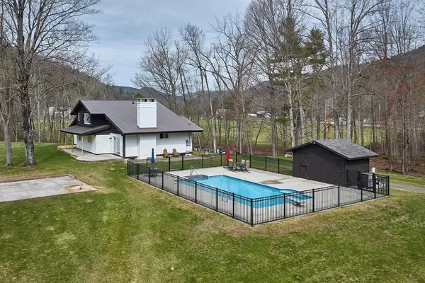 a view of house with backyard and outdoor seating
