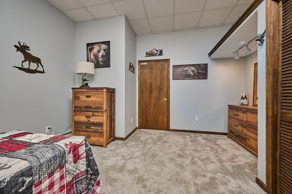 a bedroom with a bed and a view of bedroom