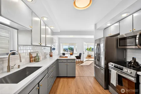 a kitchen with stainless steel appliances a refrigerator sink and cabinets