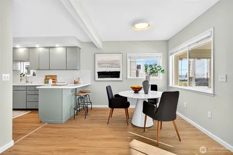 a living room with furniture a dining table and chairs with wooden floor