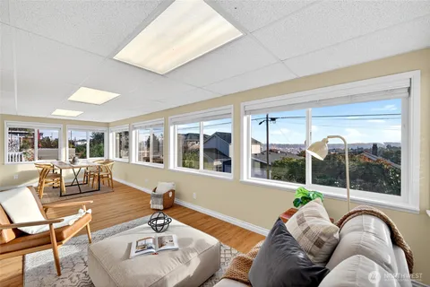 a living room with furniture and large windows