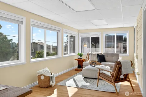 a living room with furniture and floor to ceiling windows