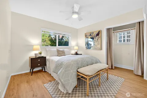 a bedroom with a bed and a painting on the wall