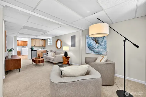 a living room with furniture and a chandelier