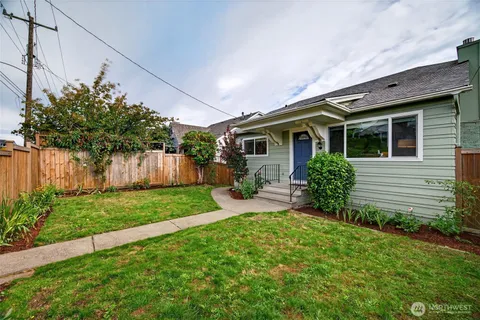 a front view of house with a garden and patio
