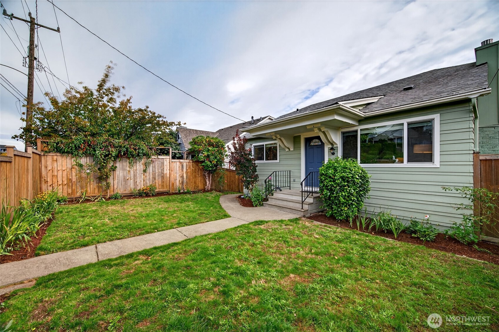 3846 35th Avenue Southwest Seattle, WA 98126 - Photo 3 of 40 a front view of house with a garden and patio