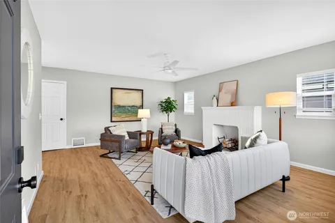 a living room with furniture and a wooden floor