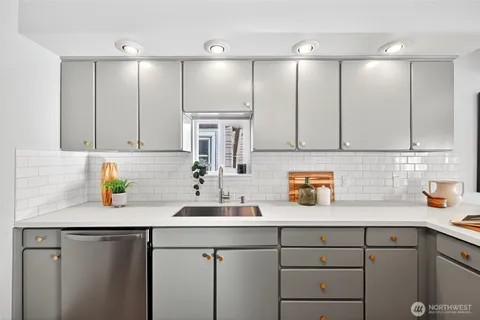a kitchen with a sink cabinets and window
