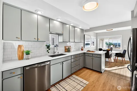 a kitchen with a sink cabinets and window