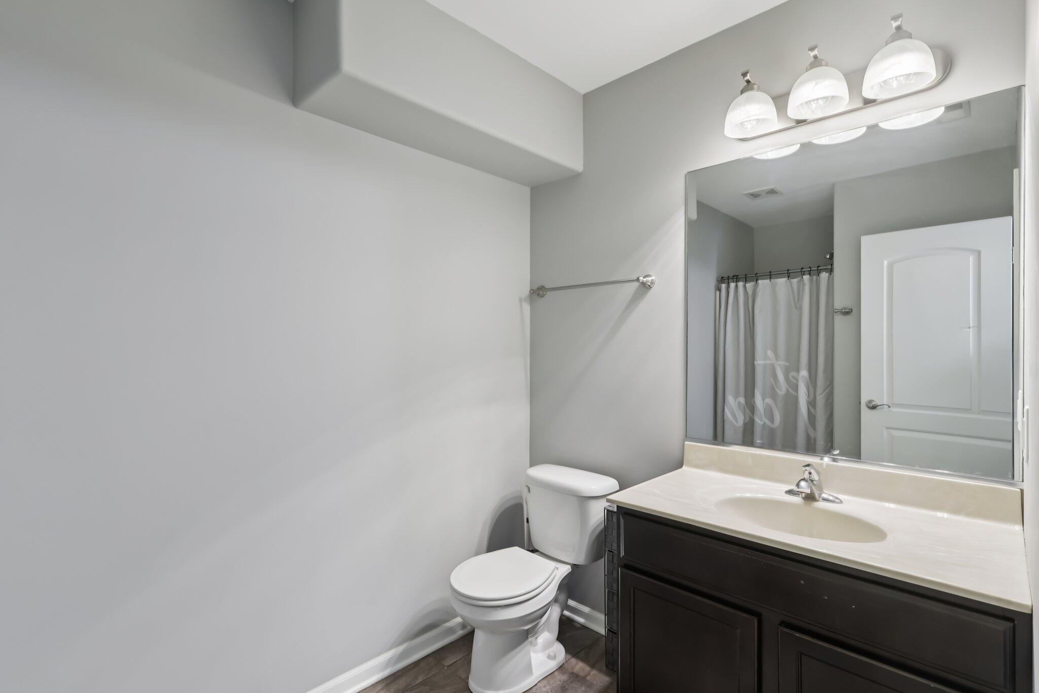 2235 Coldspring Road Crown Point, IN 46307 - Photo 19 of 51 a bathroom with a toilet sink and mirror