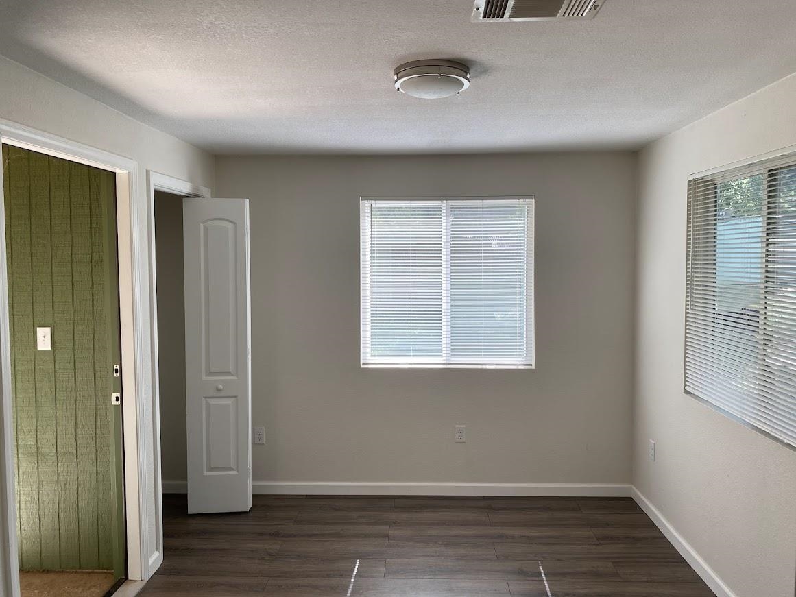 7838 Nimitz Road Millington, TN 38053 - Photo 13 of 14 Empty room with a textured ceiling and dark wood-type flooring