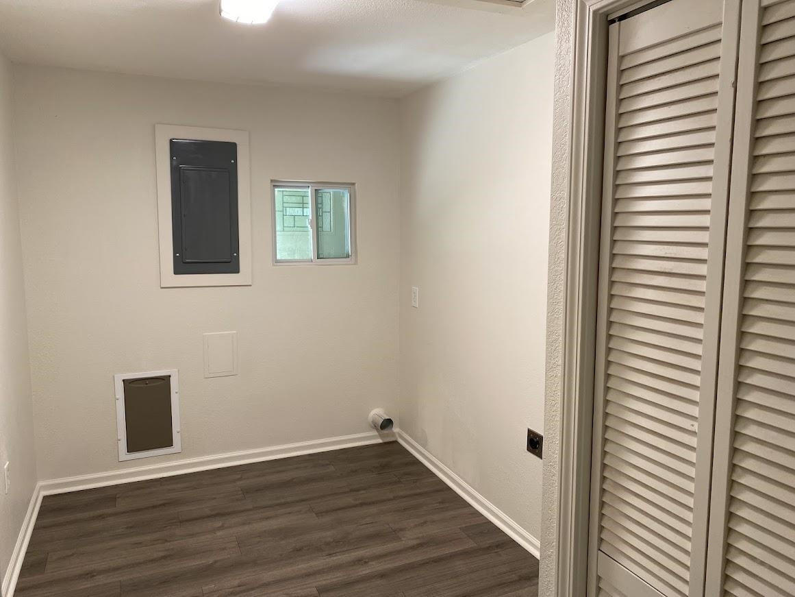 7838 Nimitz Road Millington, TN 38053 - Photo 6 of 14 Laundry area with electric panel, hookup for an electric dryer, and dark wood-type flooring
