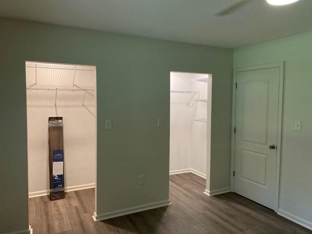 7838 Nimitz Road Millington, TN 38053 - Photo 8 of 14 Unfurnished bedroom with a spacious closet, ceiling fan, dark wood-type flooring, and a closet