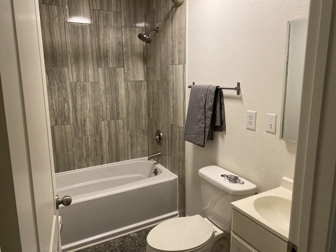 7838 Nimitz Road Millington, TN 38053 - Photo 9 of 14 Full bathroom with tile patterned floors, toilet, vanity, and tiled shower / bath