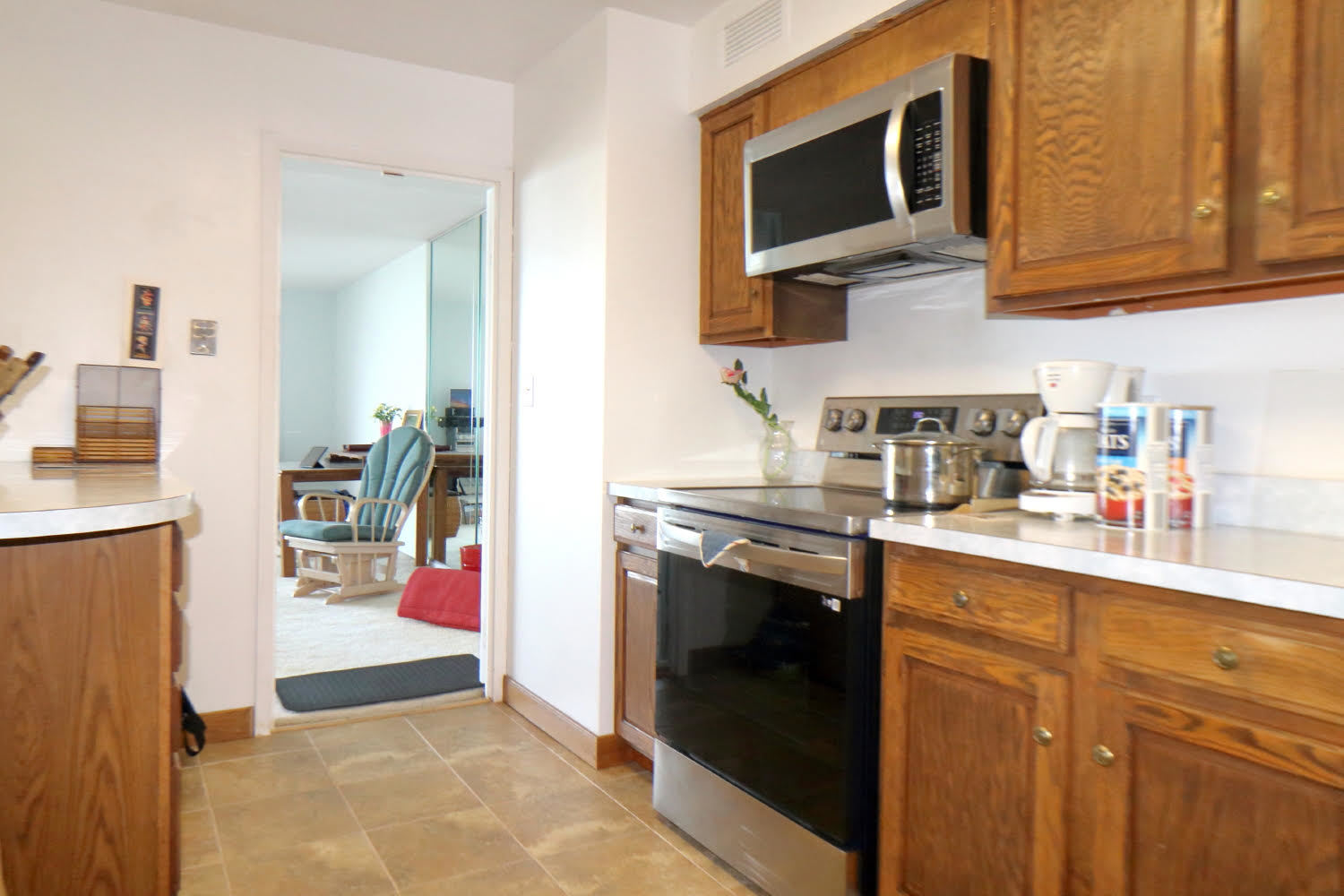 6033 North Sheridan Road, Unit 23F Chicago, IL 60660 - Photo 16 of 30 a kitchen with stainless steel appliances granite countertop a stove microwave and sink