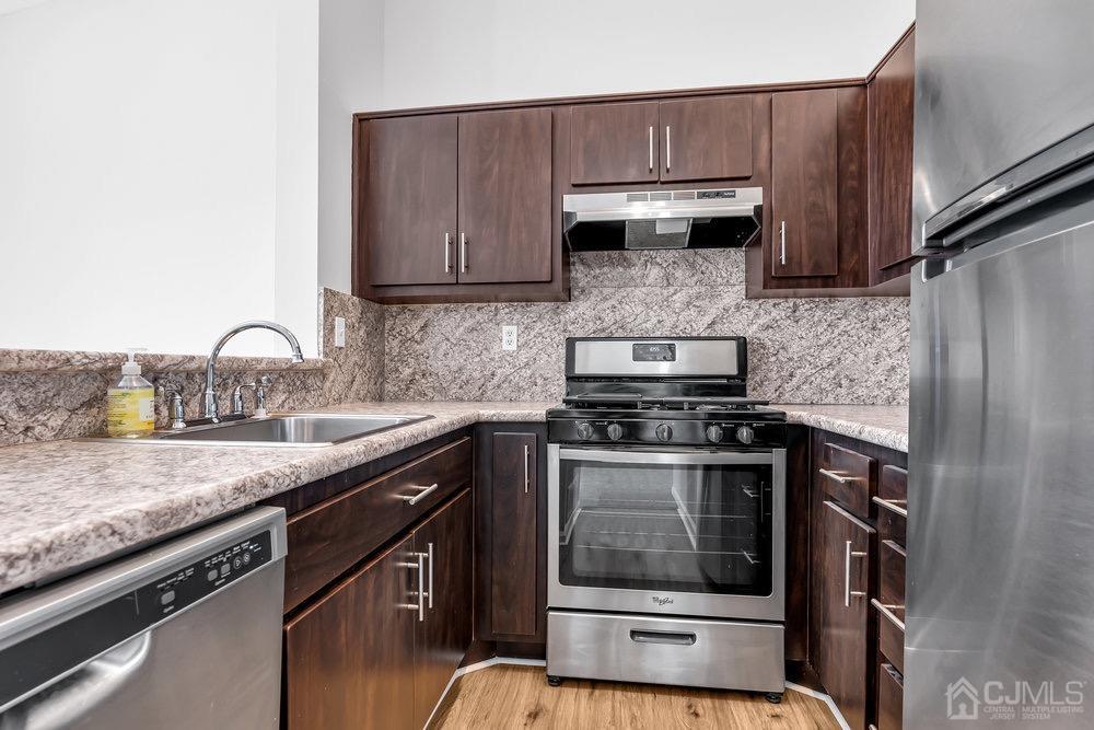 1236 Edpas Road New Brunswick, NJ 08901 - Photo 12 of 26 a kitchen with granite countertop a stove sink and cabinets